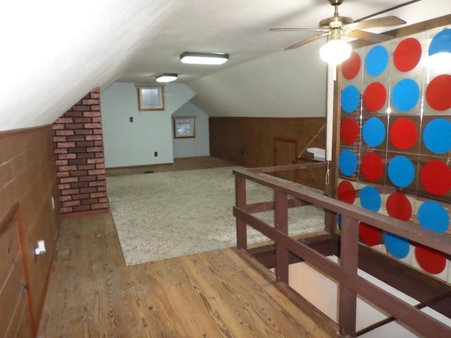 additional living space with hardwood / wood-style flooring, vaulted ceiling, and ceiling fan