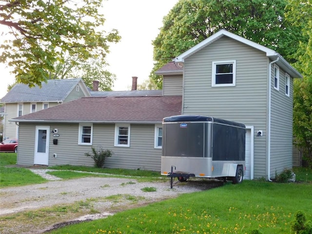 back of property featuring a yard and a sunroom