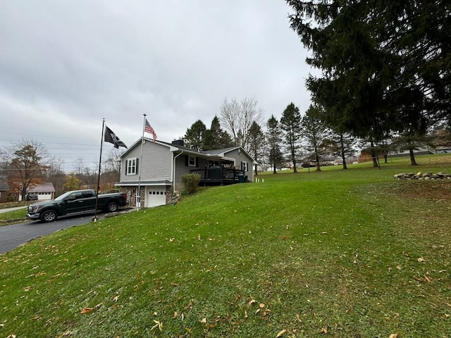 view of yard with a garage and a wooden deck