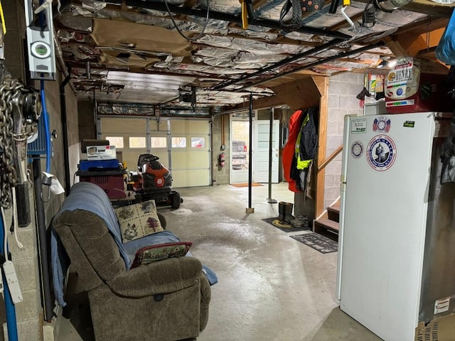 garage featuring a garage door opener and white refrigerator