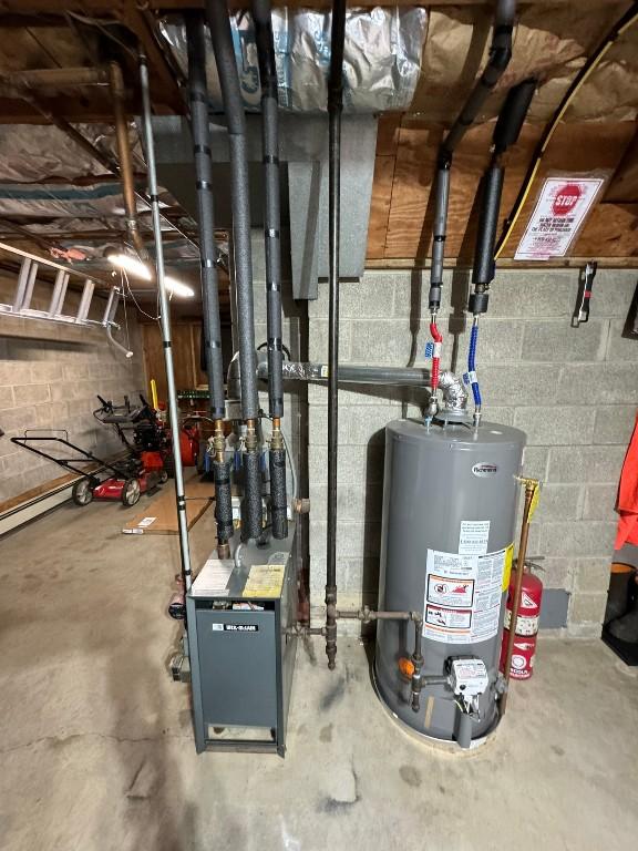 utility room featuring water heater