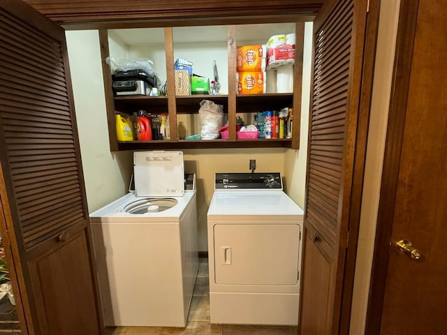 laundry room featuring washing machine and dryer and light tile patterned floors