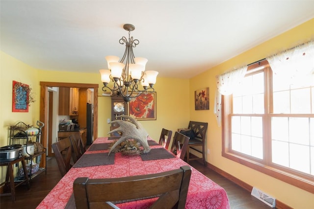 dining room featuring dark hardwood / wood-style floors and a chandelier