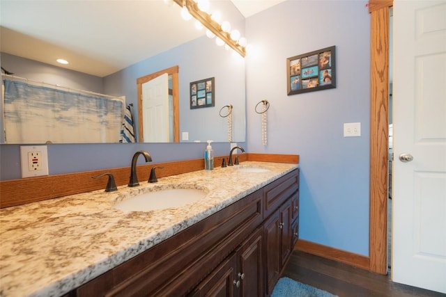 bathroom featuring hardwood / wood-style flooring, vanity, and a shower with shower curtain