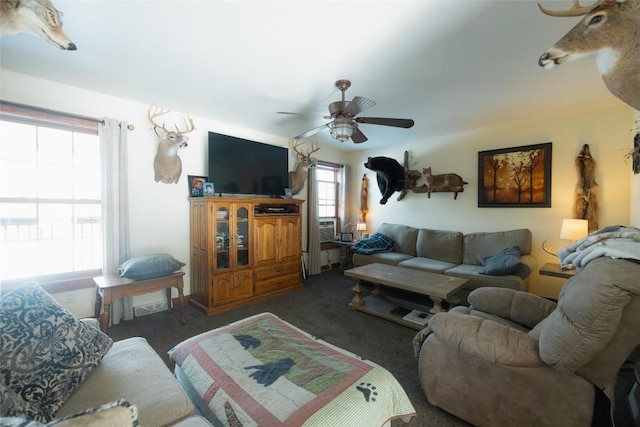 living room featuring dark colored carpet and ceiling fan