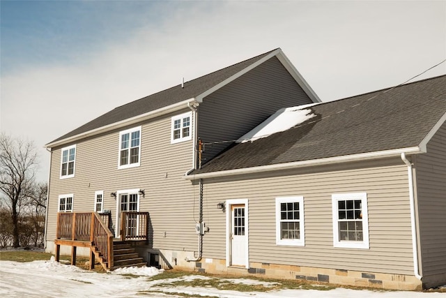 view of snow covered rear of property