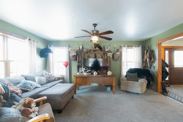 living room featuring ceiling fan, a healthy amount of sunlight, and carpet