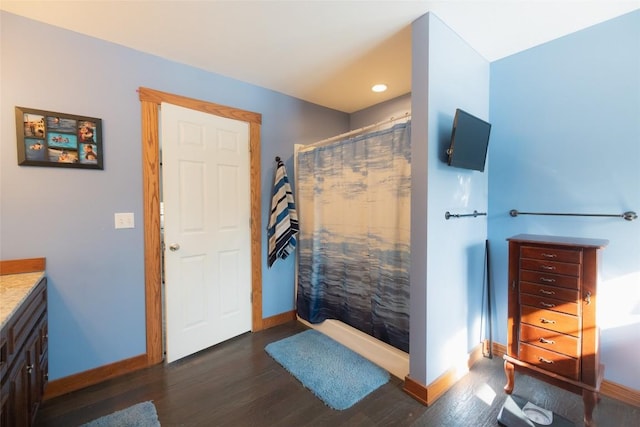 bathroom featuring vanity, curtained shower, and wood-type flooring