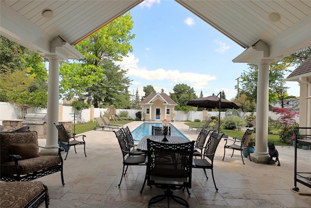 view of patio featuring an outbuilding and a fenced in pool