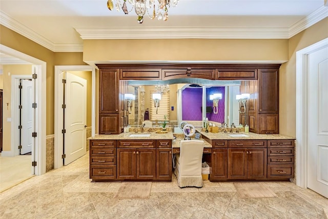 bathroom featuring vanity, ornamental molding, and an inviting chandelier