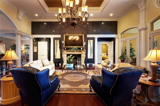 living room with a high end fireplace, french doors, dark hardwood / wood-style flooring, decorative columns, and crown molding