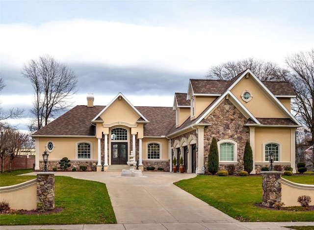 view of front facade with a front yard and a garage