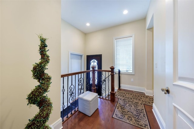 hallway with dark hardwood / wood-style floors