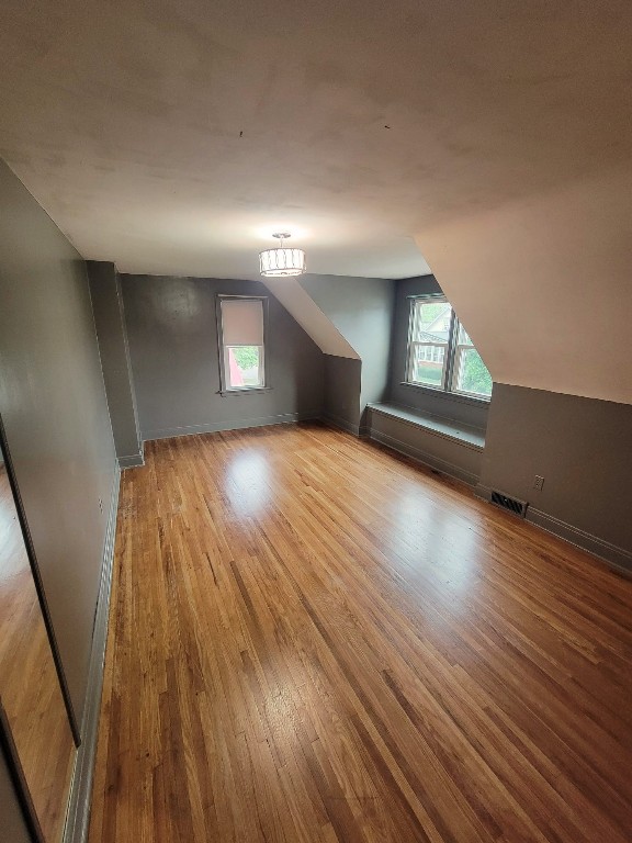 bonus room featuring light hardwood / wood-style floors and lofted ceiling