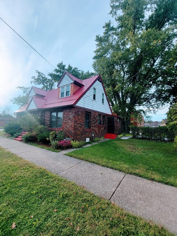 view of side of home with a lawn