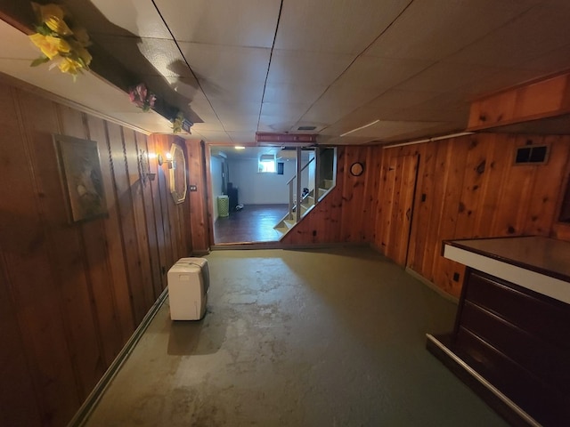 basement featuring wood walls