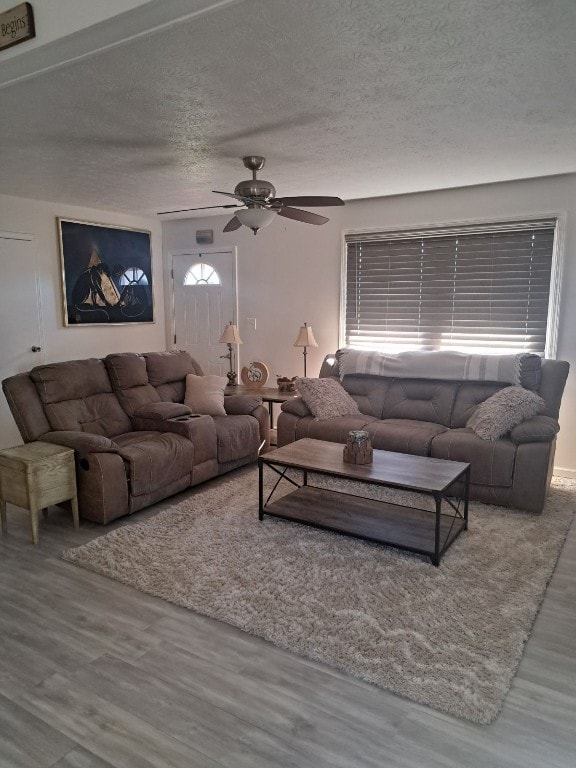 315 Wallace Ave, Linesville, PA 16424 - living room with wood finished floors, ceiling fan, and a textured ceiling