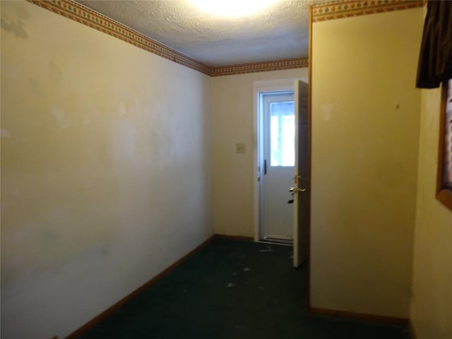 hallway with a textured ceiling