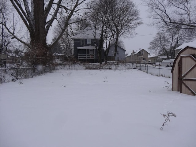 snowy yard with a storage unit