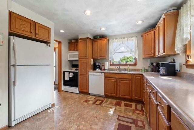 6946 Huntley Rd, West Springfield, PA 16443 - kitchen featuring white appliances, brown cabinetry, light countertops, recessed lighting, and stone finish floors