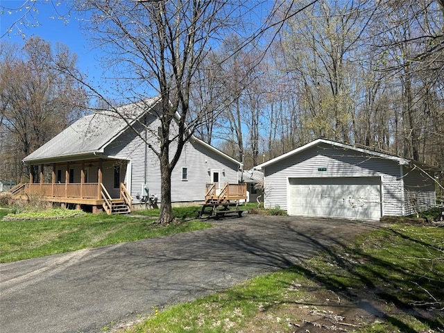 exterior space with an outdoor structure, covered porch, and a detached garage