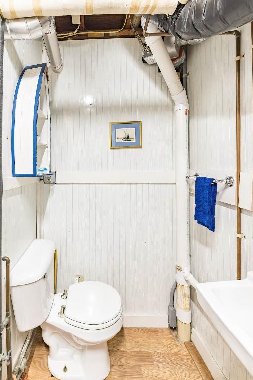 bathroom with hardwood / wood-style floors and toilet