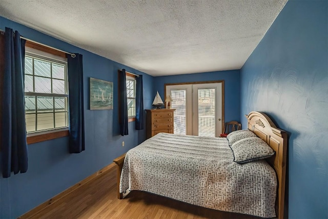 bedroom with a textured ceiling and hardwood / wood-style flooring