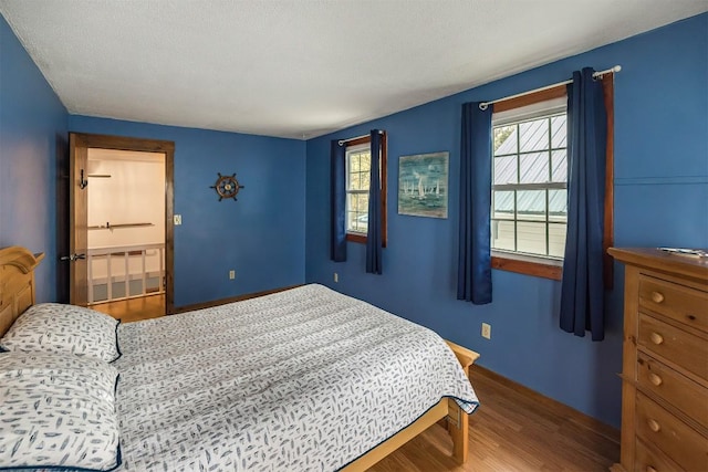 bedroom with wood-type flooring and a textured ceiling