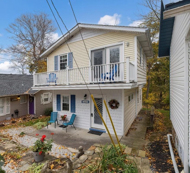 back of property with a patio area and a balcony