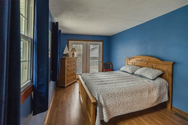 bedroom featuring wood-type flooring and a textured ceiling