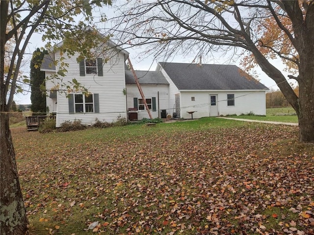 back of house featuring a yard and a deck