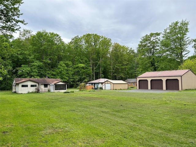 2892 Township Rd, Linesville, PA 16424 - view of green lawn with a detached garage and an outdoor structure