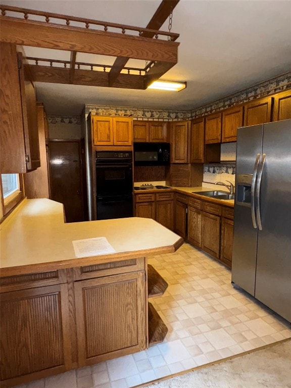 2810 E 28th St, Erie, PA 16510 - kitchen with black appliances, a peninsula, brown cabinets, light floors, and light countertops