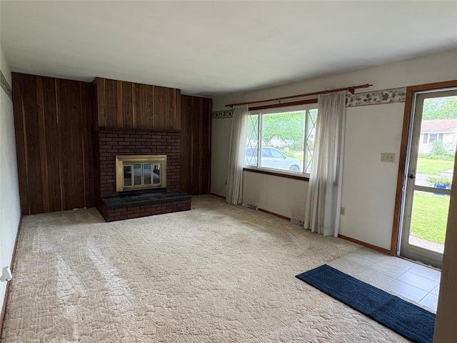 2810 E 28th St, Erie, PA 16510 - unfurnished living room with healthy amount of natural light, wood walls, and a brick fireplace