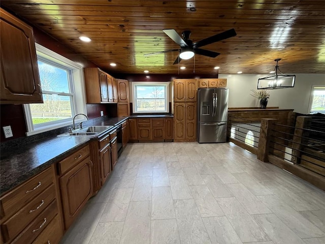 kitchen with dark countertops, wooden ceiling, a sink, and stainless steel fridge with ice dispenser