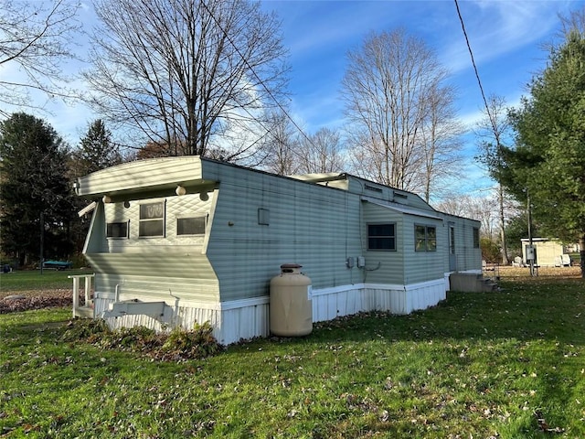 view of home's exterior with a yard