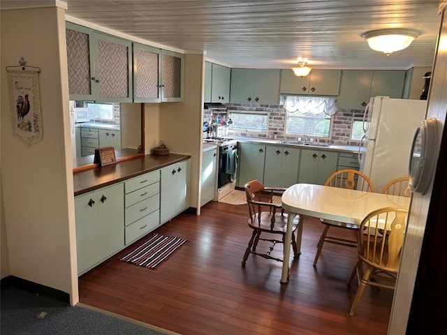 kitchen featuring dark wood-type flooring, white refrigerator, sink, gas range, and dishwashing machine