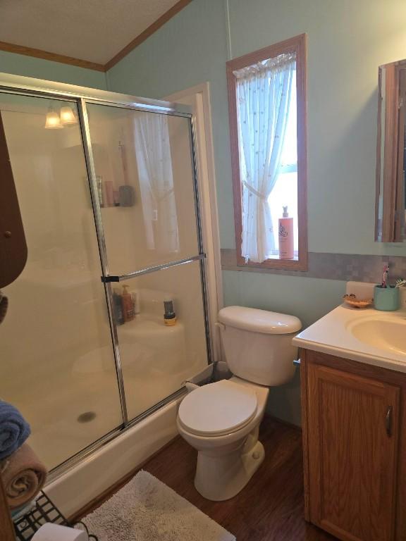 2719 Green Hill Dr, Millcreek, PA 16506 - bathroom featuring a shower stall, wood finished floors, ornamental molding, and vanity