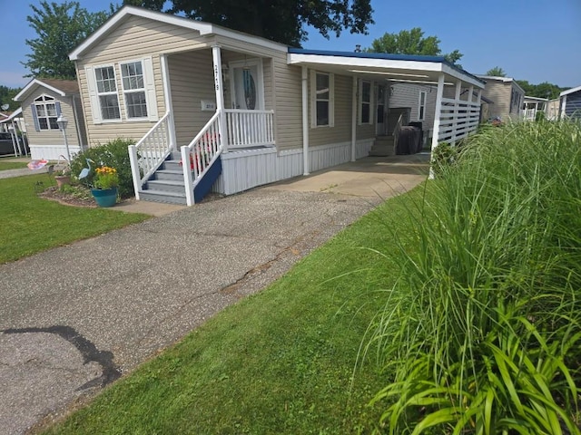 2719 Green Hill Dr, Millcreek, PA 16506 - manufactured / mobile home with driveway, a carport, and a front lawn