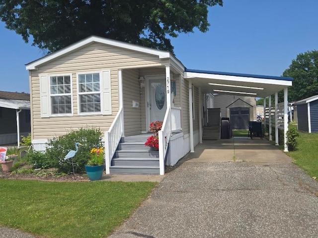 2719 Green Hill Dr, Millcreek, PA 16506 - manufactured / mobile home featuring driveway, an attached carport, and a front lawn