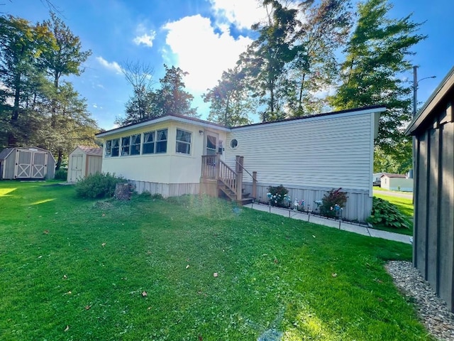 view of front facade featuring a front lawn and a storage shed