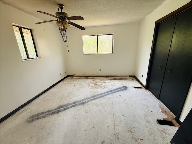 unfurnished bedroom with baseboards and ceiling fan