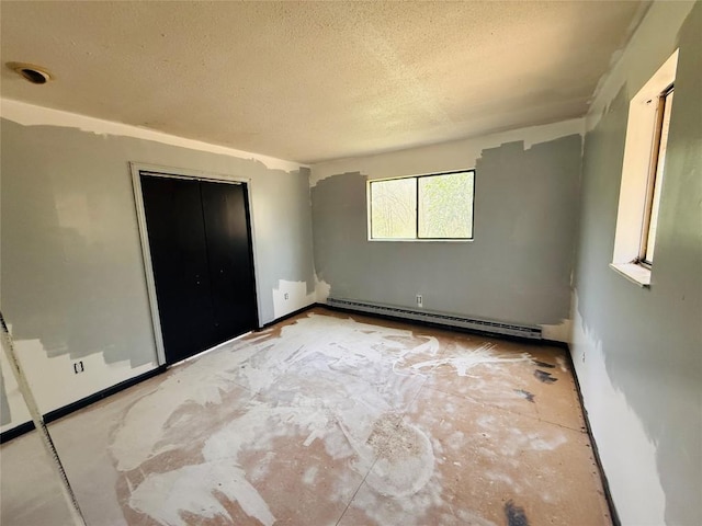 unfurnished bedroom featuring a closet, a baseboard radiator, and a textured ceiling