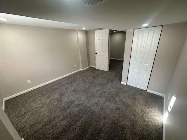 basement with dark colored carpet