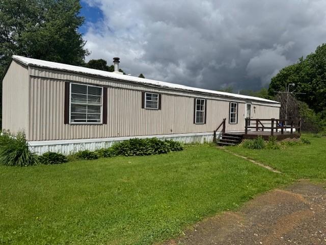 2409 N Shore Dr, Linesville, PA 16424 - manufactured / mobile home featuring a deck and a front lawn