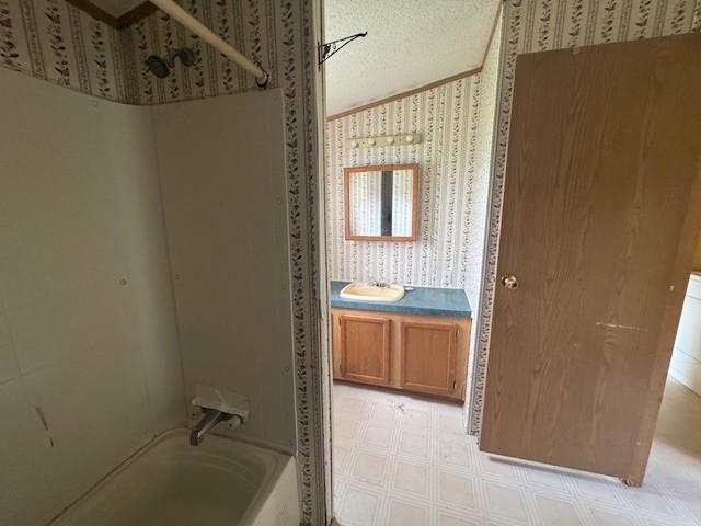2409 N Shore Dr, Linesville, PA 16424 - bathroom with wallpapered walls, tile patterned floors, vanity, shower / tub combination, and a textured ceiling