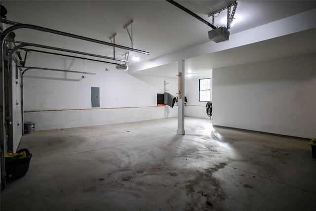 garage with electric panel and a garage door opener