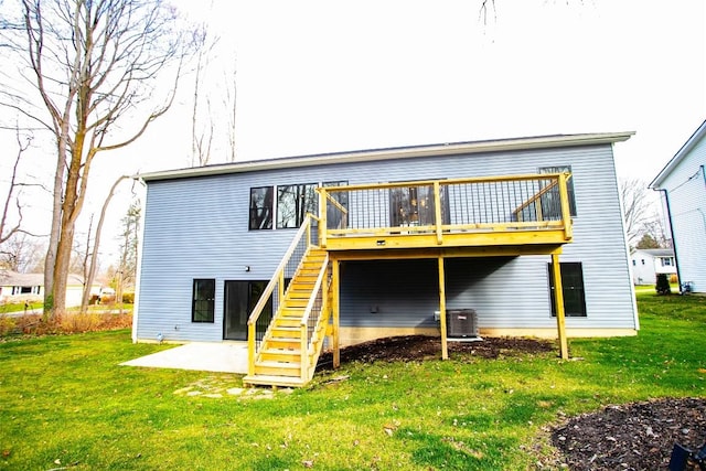 rear view of house featuring a lawn, a patio area, cooling unit, and a deck