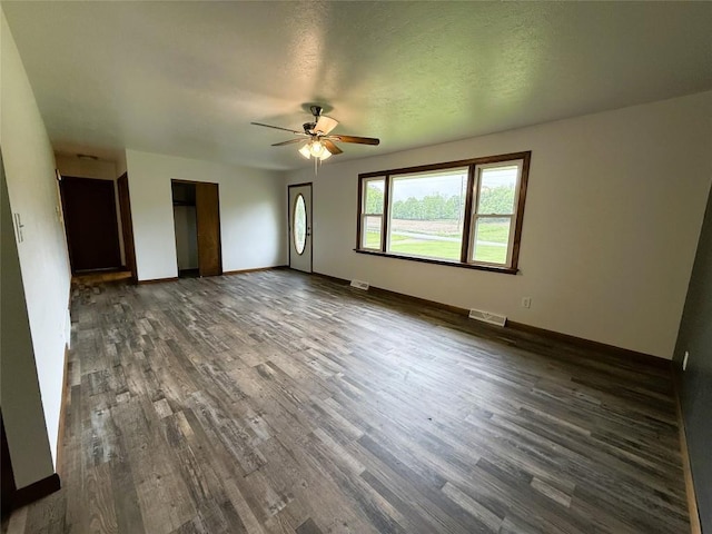 31050 US Highway 322, Cochranton, PA 16314 - unfurnished living room featuring dark wood-type flooring, ceiling fan, and baseboards