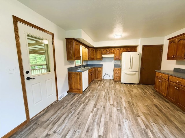 31050 US Highway 322, Cochranton, PA 16314 - kitchen featuring white appliances, light wood-type flooring, a sink, and dark countertops